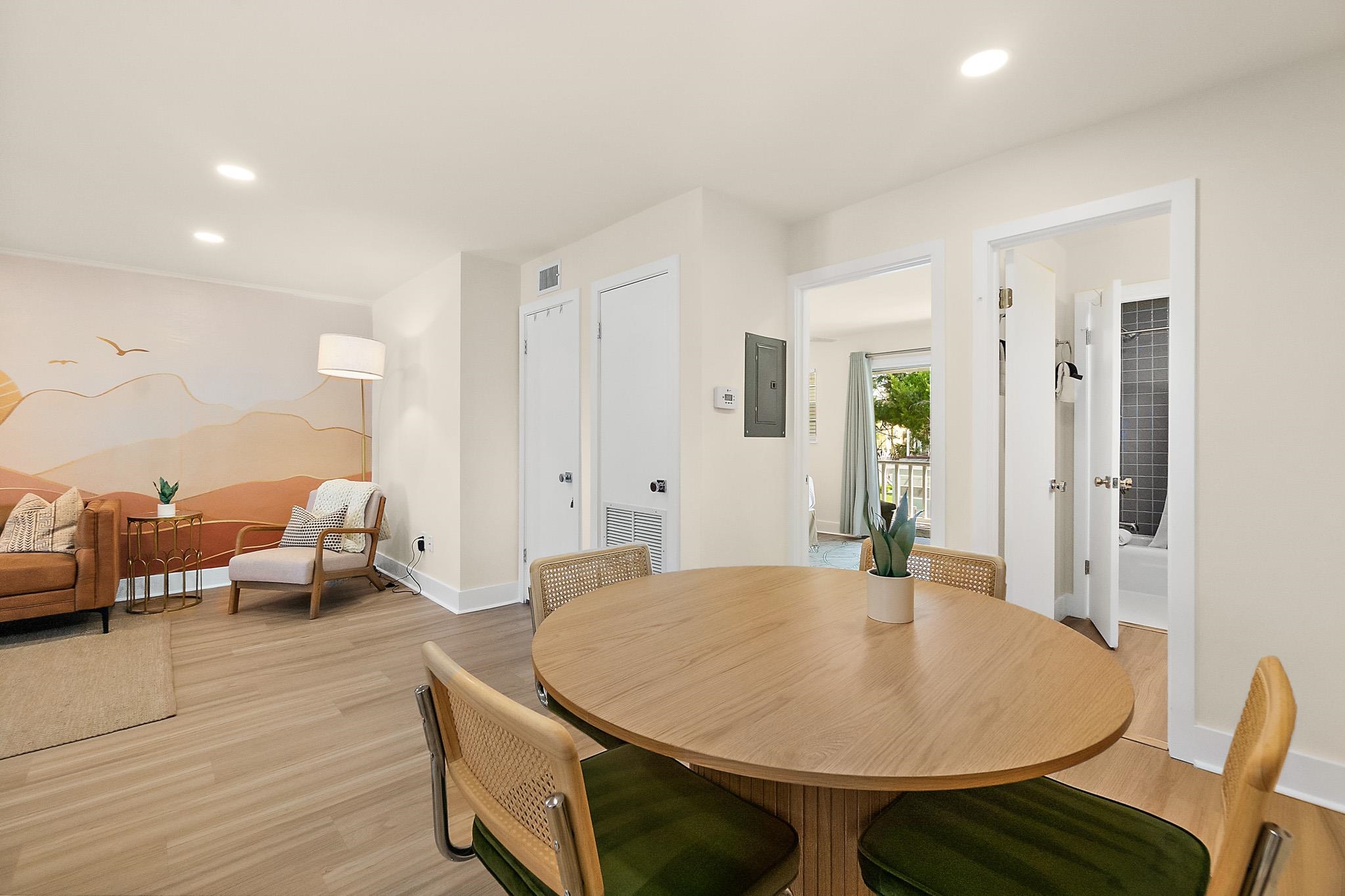 405 Flagler Boulevard, Unit 8A St. Augustine, FL 32080 - Photo 9 of 35 a living room with dining table and wooden floor