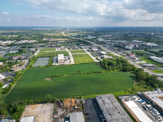 an aerial view of a residential building with an outdoor space