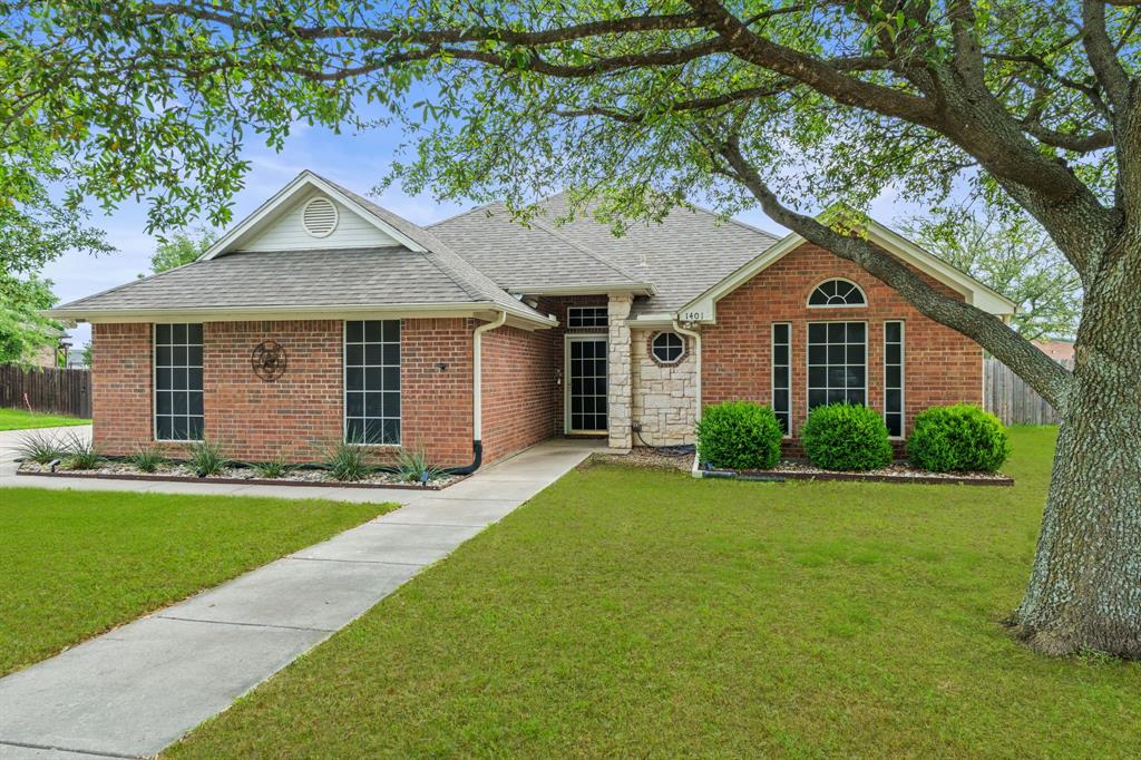 Brick facade home with a partial stone accent wall