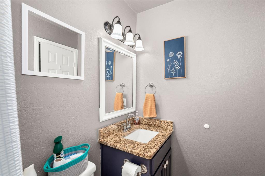 1401 Hickory Drive Pilot Point, TX 76258 - Photo 14 of 34 Bathroom vanity with a granite-style countertop and an integrated sink
