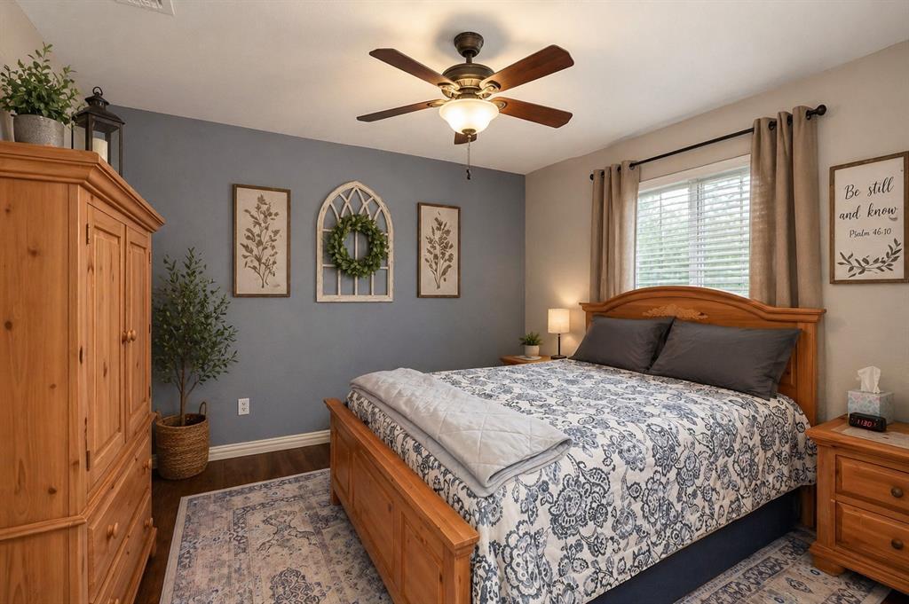 1401 Hickory Drive Pilot Point, TX 76258 - Photo 15 of 34 Bedroom featuring wood-finish flooring, a ceiling fan with integrated lighting, and a single window with blinds
