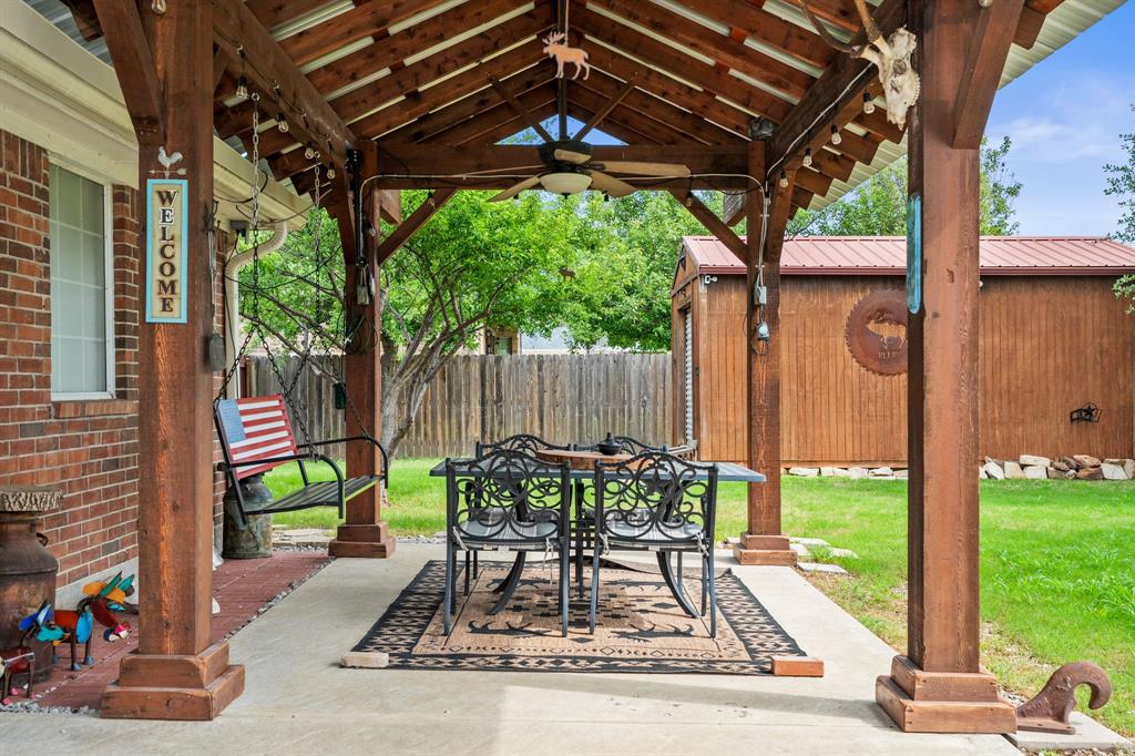 1401 Hickory Drive Pilot Point, TX 76258 - Photo 19 of 34 Covered outdoor patio featuring a wood-beam pergola with a metal roof