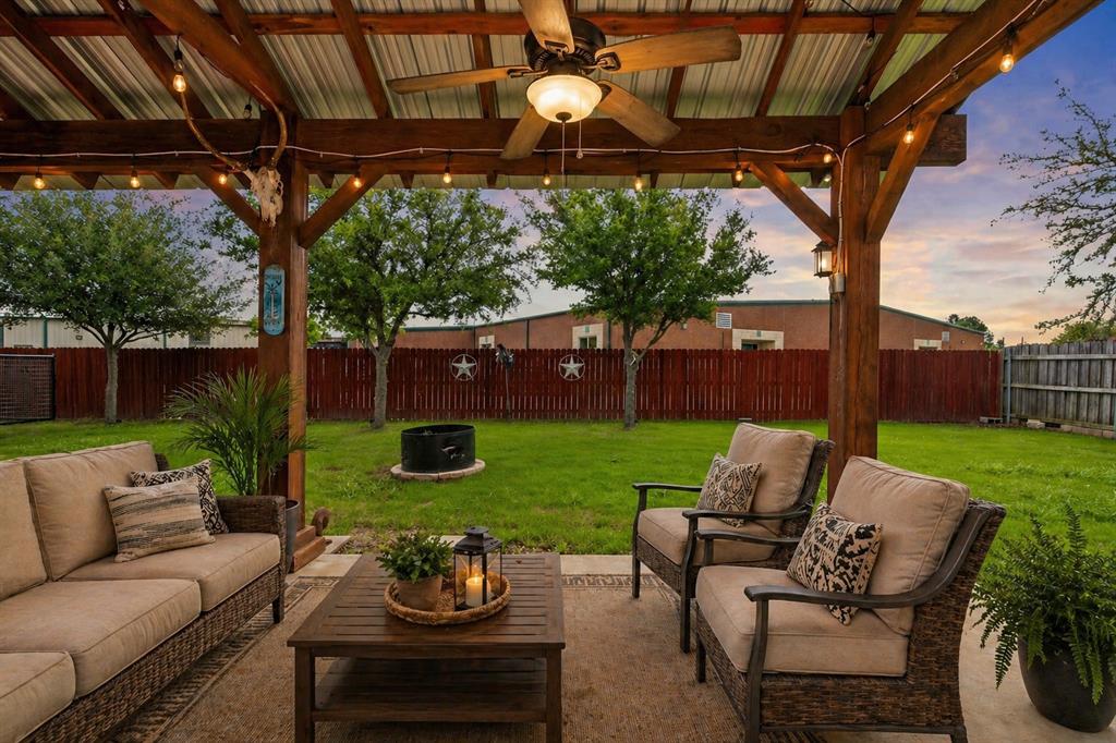 1401 Hickory Drive Pilot Point, TX 76258 - Photo 20 of 34 Covered patio featuring a wood-beam pergola and corrugated metal roof