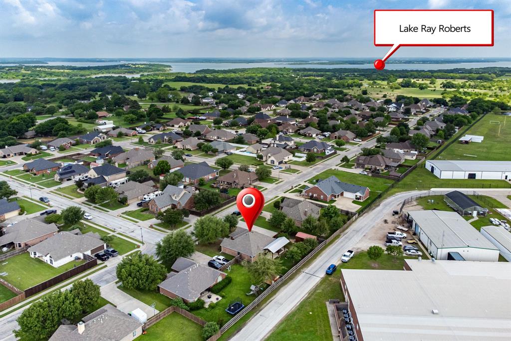 1401 Hickory Drive Pilot Point, TX 76258 - Photo 32 of 34 Aerial perspective highlighting a residential neighborhood with Lake Ray Roberts in the distance