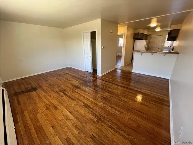 a view of a living room with wooden floor