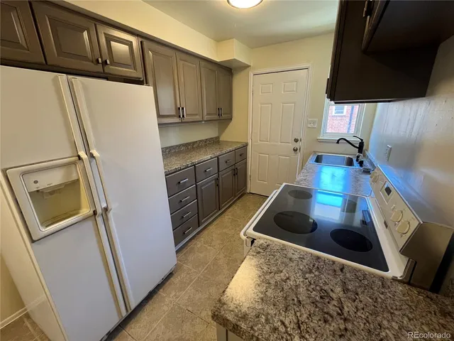 a kitchen with a refrigerator a stove a sink and dishwasher
