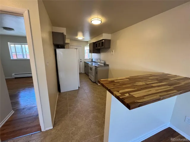 a kitchen with a stove and a refrigerator