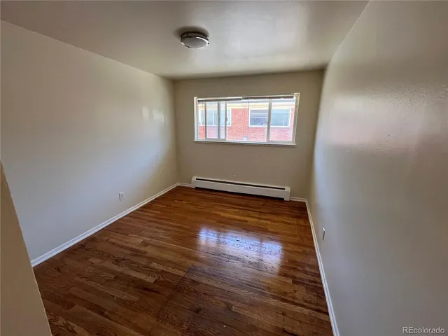 an empty room with wooden floor
