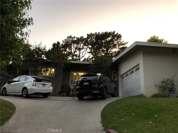 a view of a car parked in back of a house