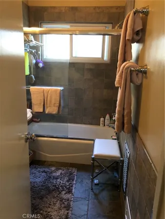 a bathroom with a bathtub and a shower