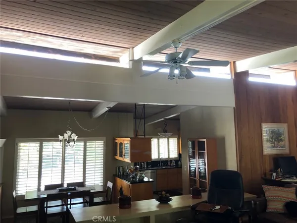 a view of a dining room with furniture and chandelier