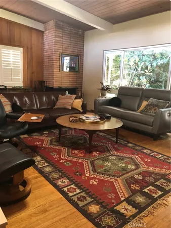 a living room with furniture rug and window