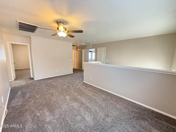 a view of a kitchen with a sink and a chandelier fan