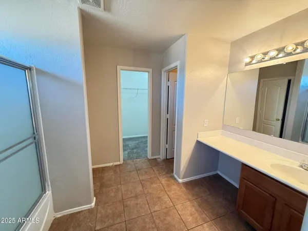 a room with a sink and a mirror