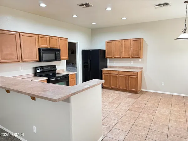 a kitchen with stainless steel appliances a refrigerator and a stove top oven