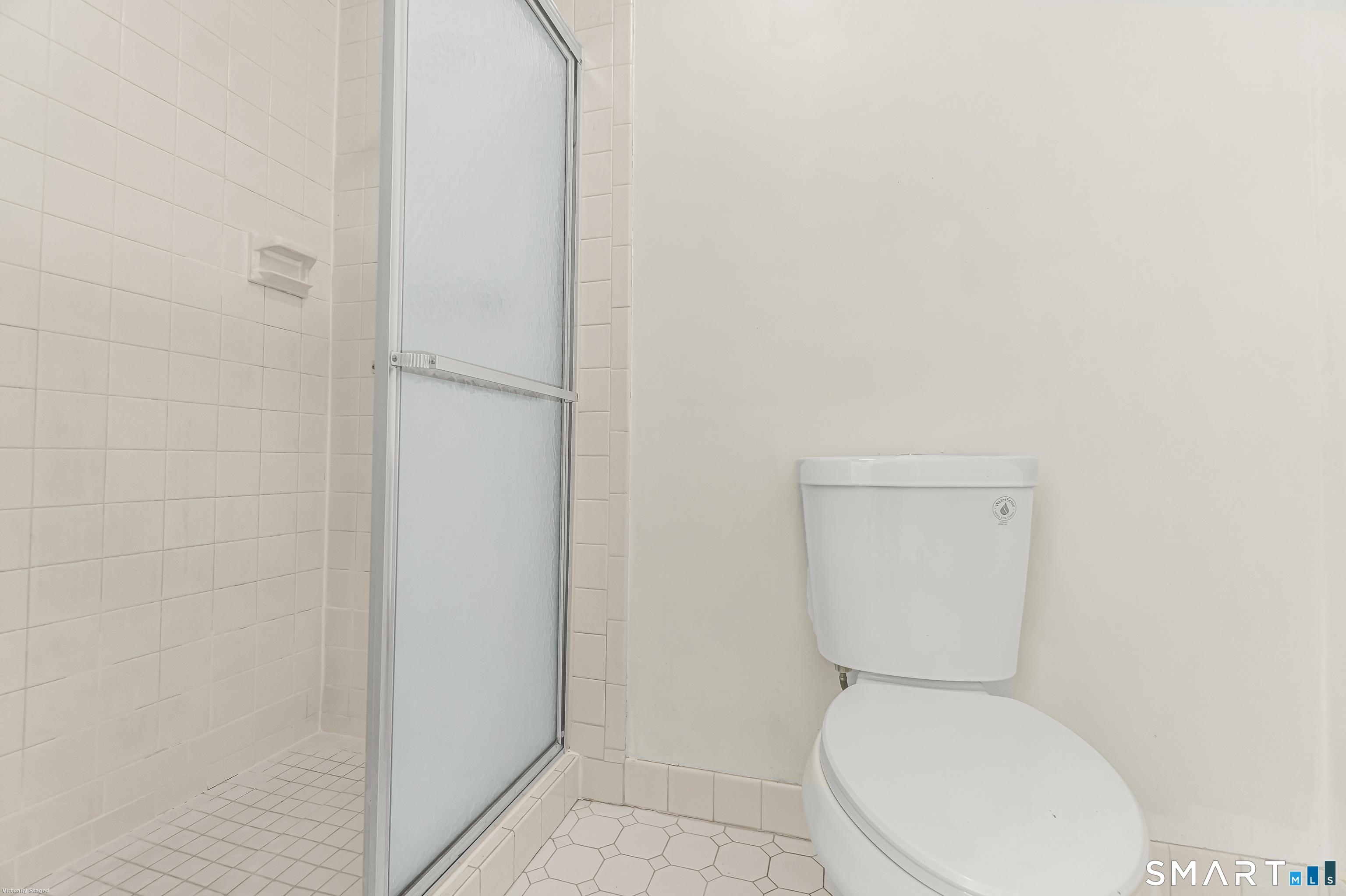 4023 Park Avenue, Unit 4023 Fairfield, CT 06825 - Photo 11 of 25 a white toilet sitting next to a white wall