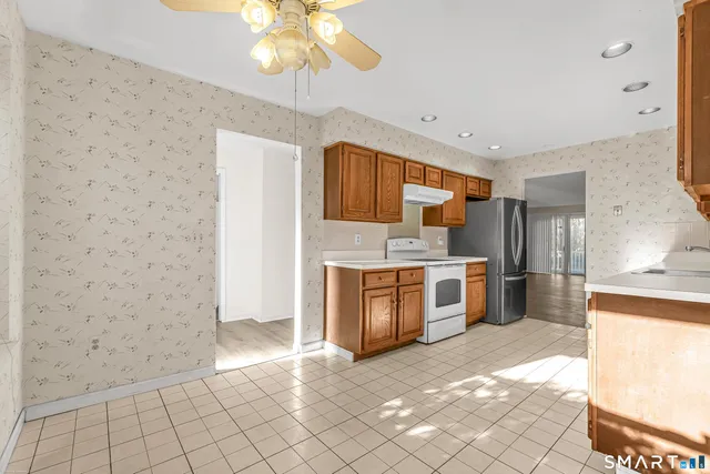 a large kitchen with cabinets and stainless steel appliances