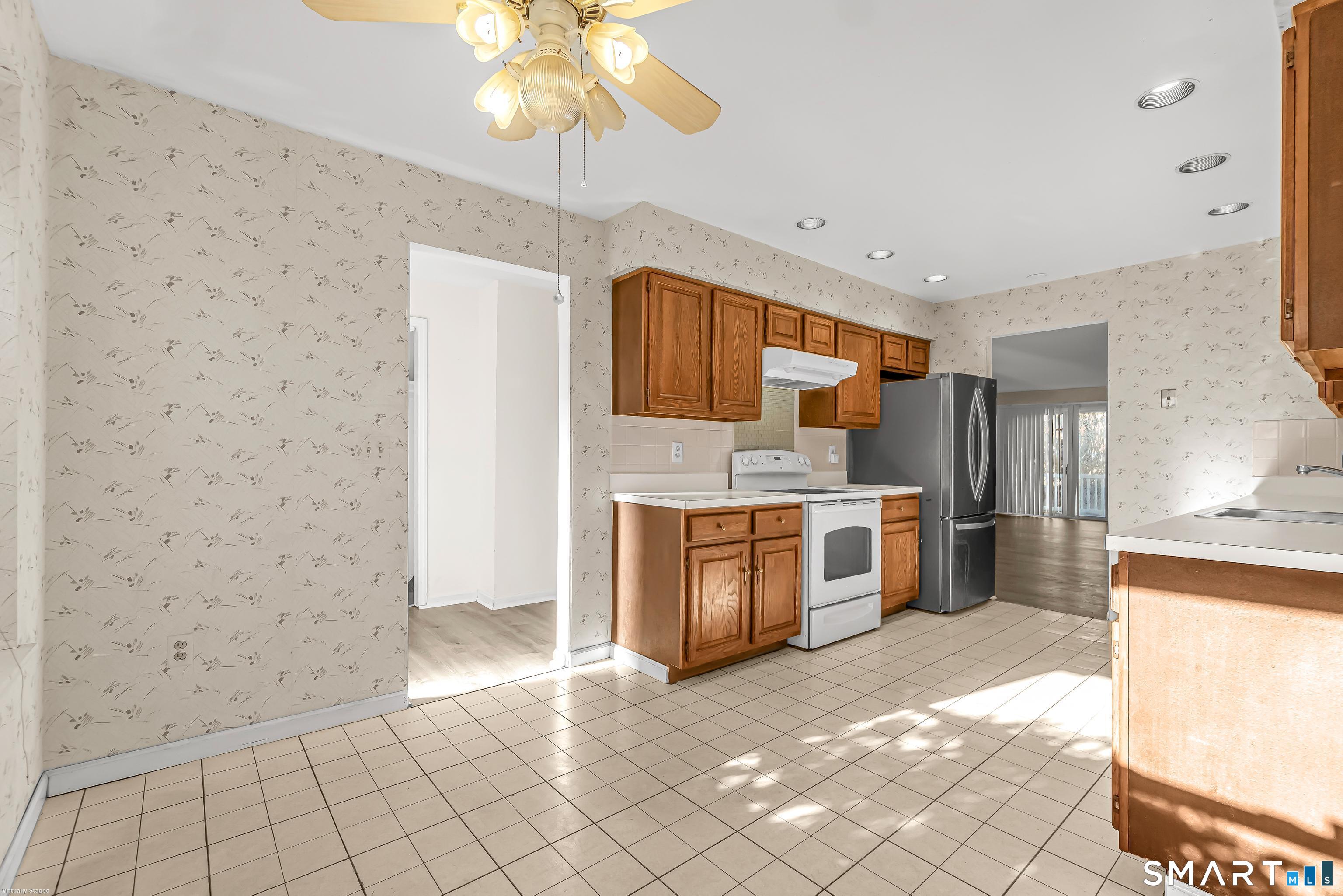 4023 Park Avenue, Unit 4023 Fairfield, CT 06825 - Photo 14 of 25 a large kitchen with cabinets and stainless steel appliances