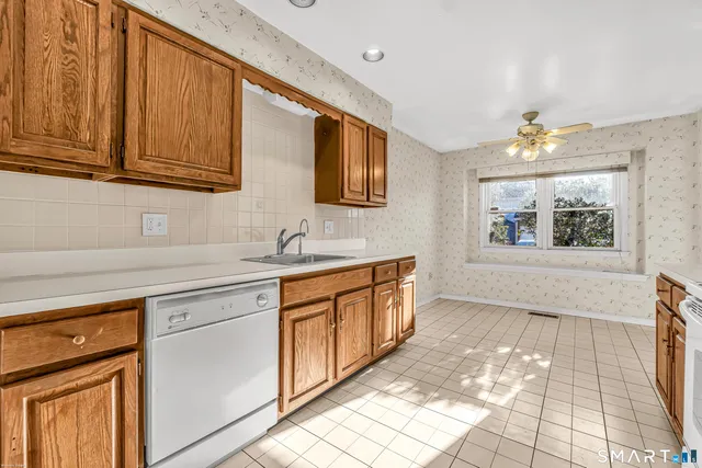 a kitchen with stainless steel appliances granite countertop a sink dishwasher stove and cabinets
