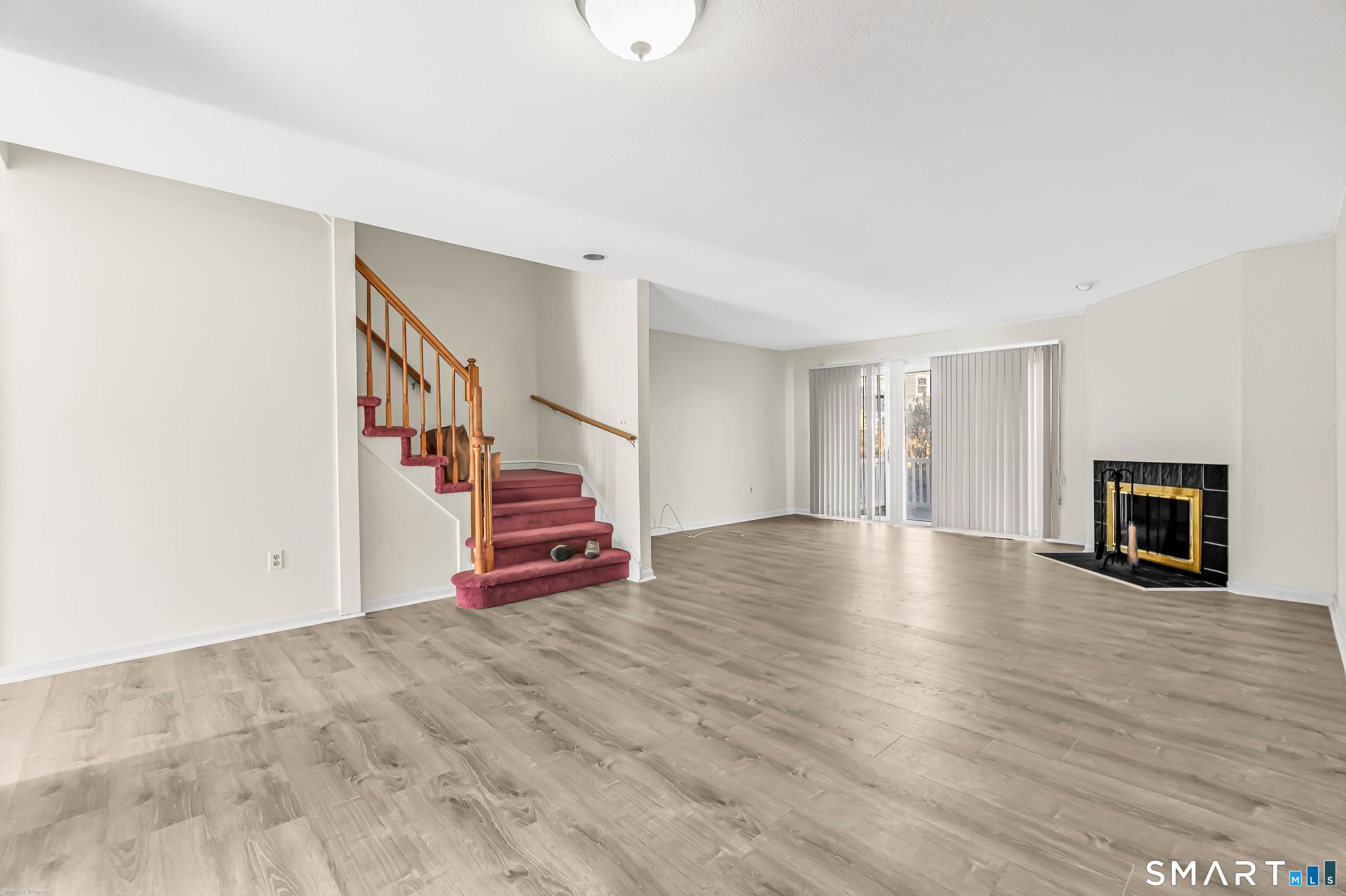 4023 Park Avenue, Unit 4023 Fairfield, CT 06825 - Photo 18 of 25 a view of an empty room with wooden floor and stairs