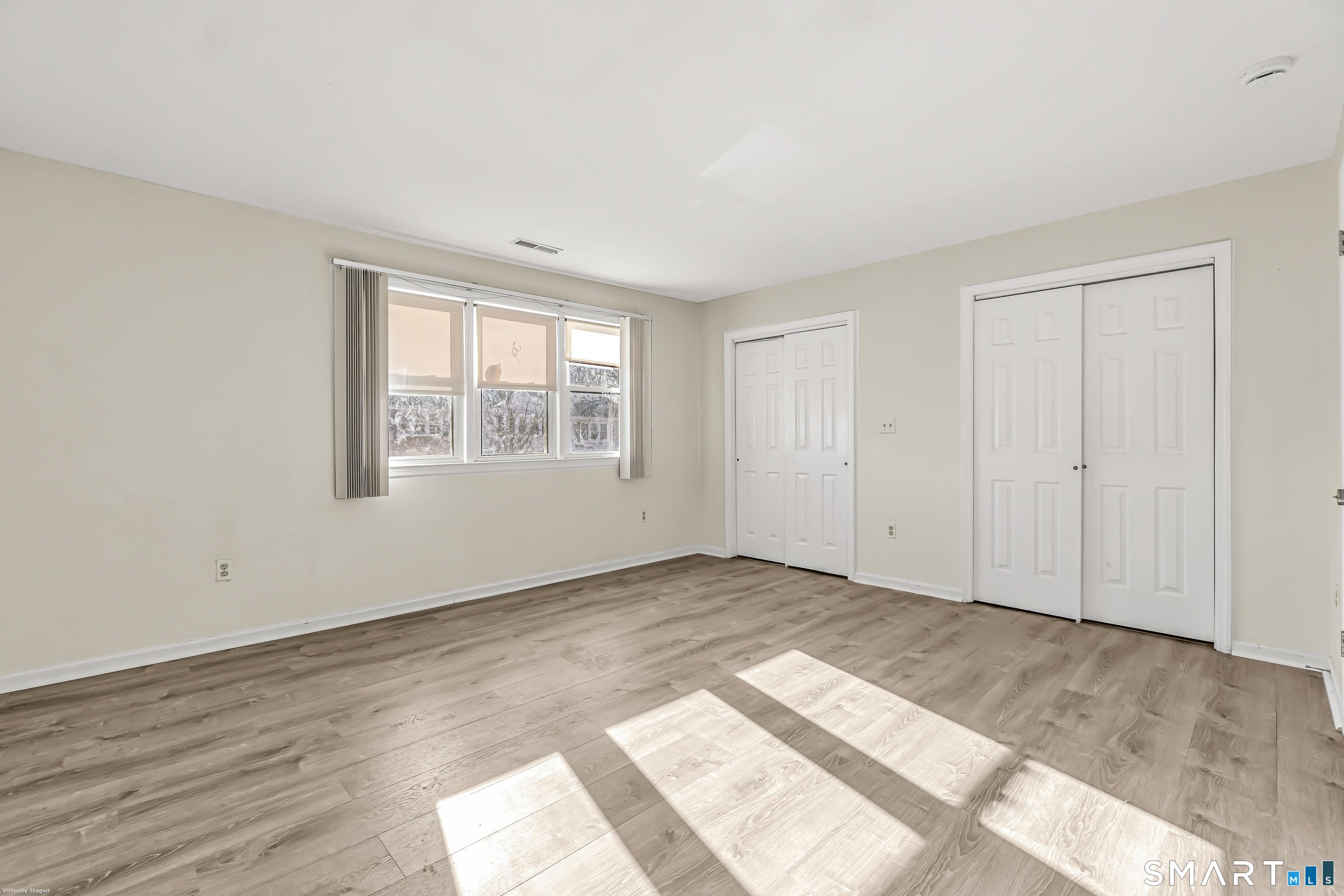 4023 Park Avenue, Unit 4023 Fairfield, CT 06825 - Photo 20 of 25 an empty room with wooden floor and windows