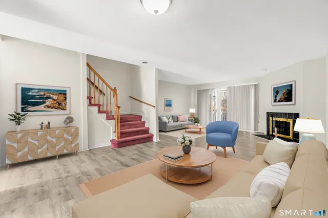 a living room with fireplace furniture and a flat screen tv