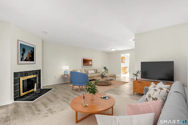 a living room with furniture a fireplace and a flat screen tv