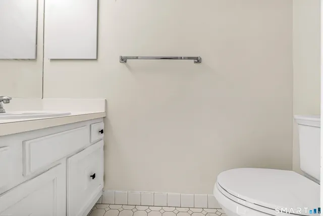 a bathroom with a sink a toilet and mirror