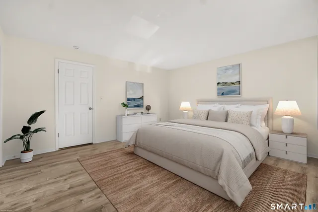 a bedroom with a bed and a table