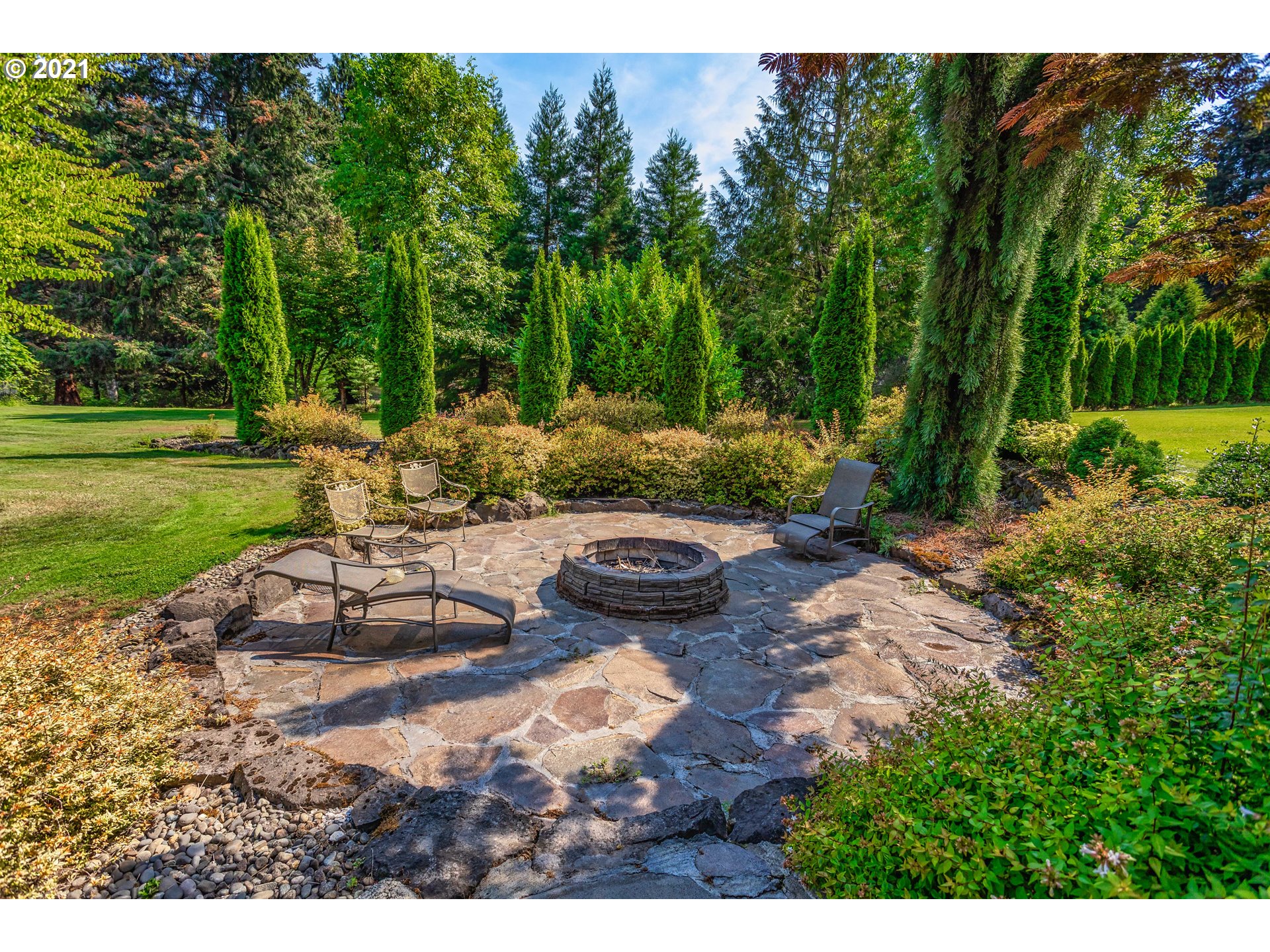 24814 Northwest 4th Court Ridgefield, WA 98642 - Photo 22 of 29 a view of a backyard with plants and outdoor seating