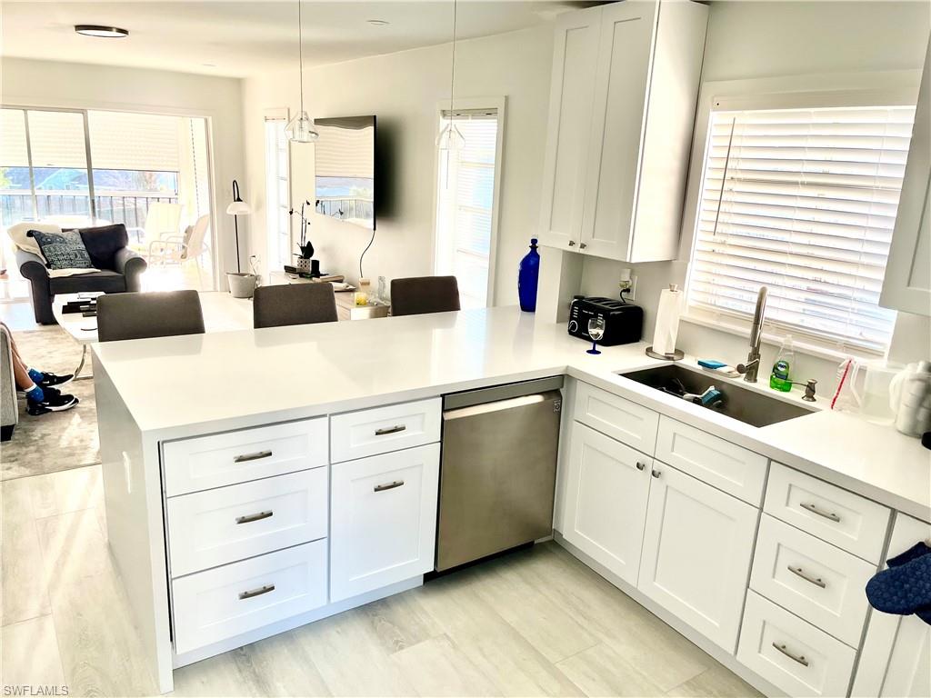 53 High Point Circle West, Unit 304 Naples, FL 34103 - Photo 1 of 8 a kitchen with cabinets oven and a large window