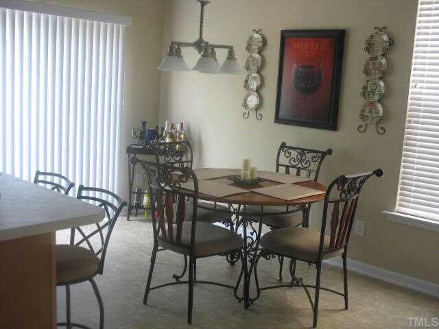 2224 Persimmon Ridge Drive Raleigh, NC 27604 - Photo 4 of 10 a view of a dining room with furniture and chandelier