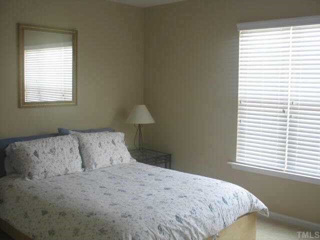 2224 Persimmon Ridge Drive Raleigh, NC 27604 - Photo 7 of 10 a bedroom with a bed and a window