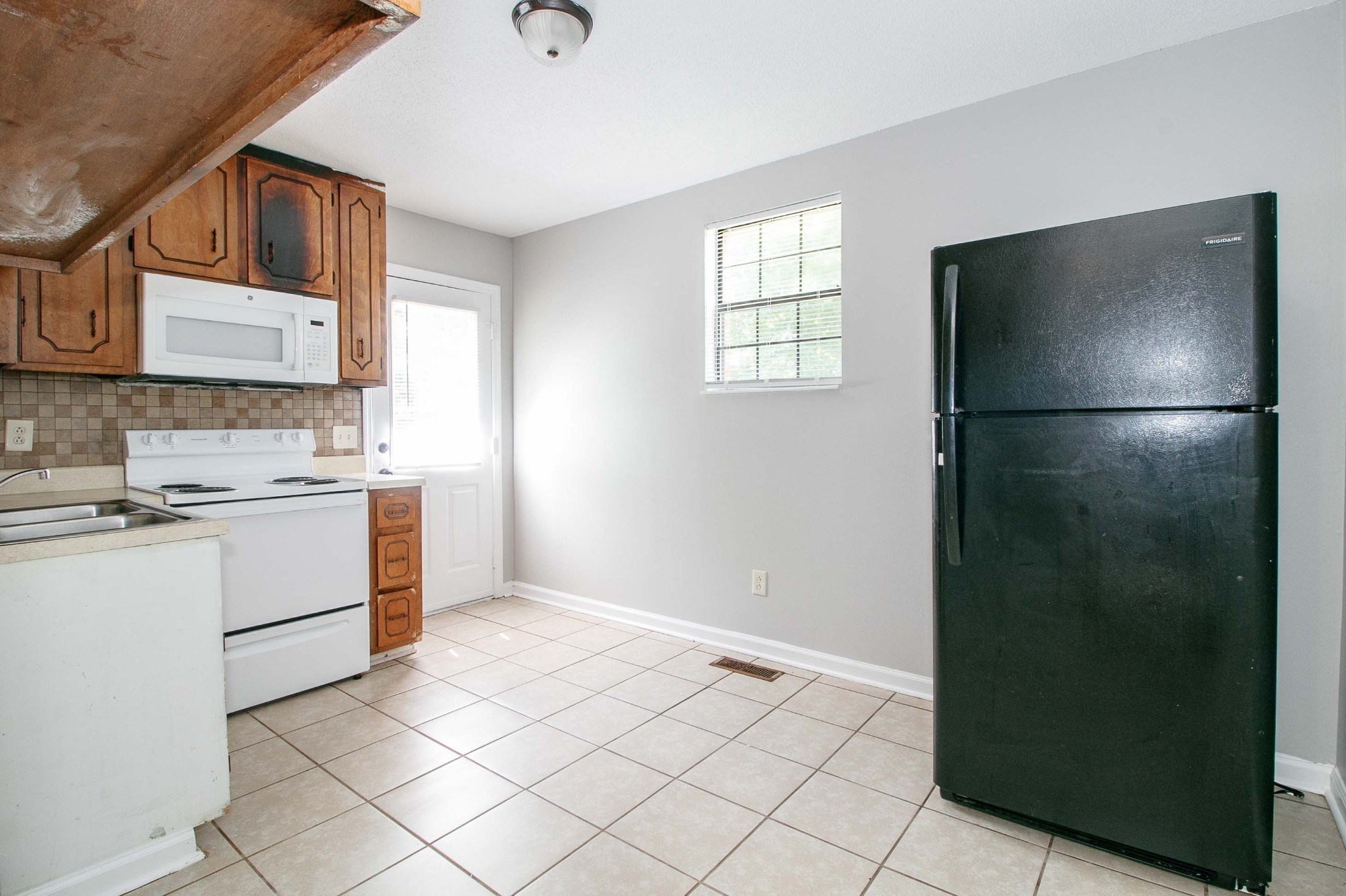 1100 Mcdaniel Road Clarksville, TN 37043 - Photo 18 of 71 a kitchen with a refrigerator sink and cabinets