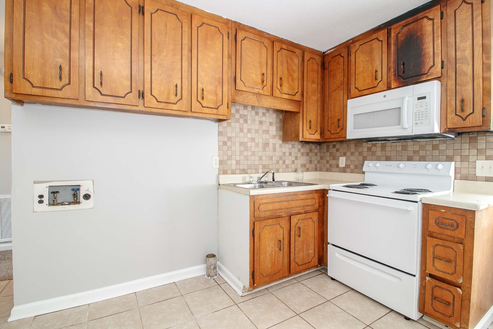 1100 Mcdaniel Road Clarksville, TN 37043 - Photo 19 of 71 a kitchen with stainless steel appliances granite countertop a sink and dishwasher a stove with wooden cabinets