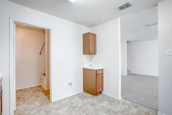 an empty room with windows and bathroom