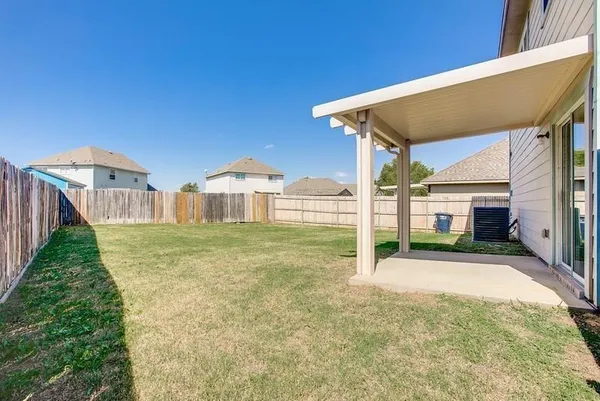 a view of a house with backyard and porch