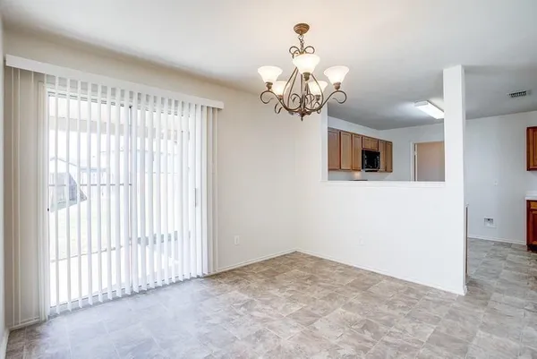 a view of a livingroom with a chandelier fan
