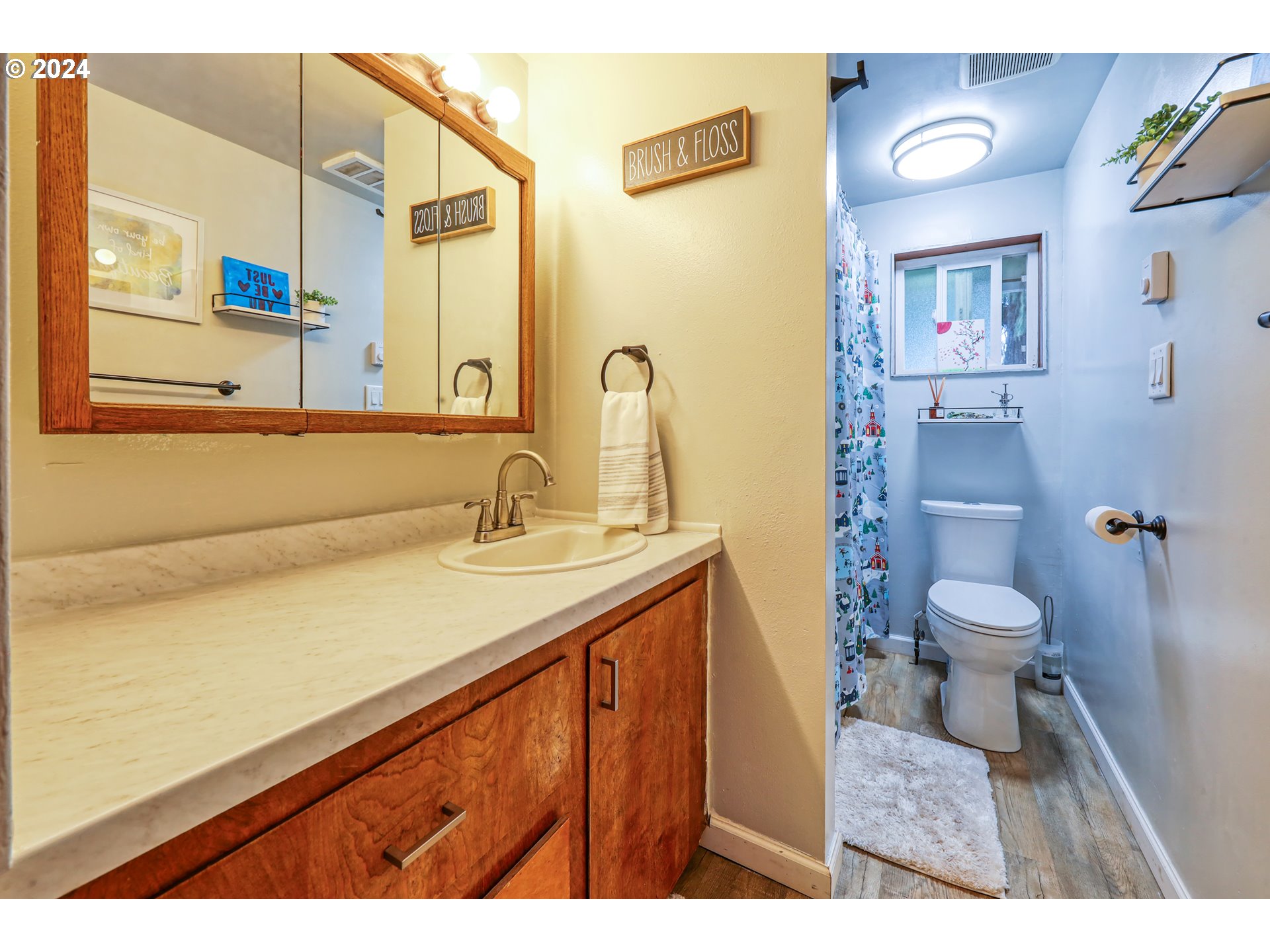 615 48th Street Springfield, OR 97478 - Photo 12 of 16 a bathroom with a sink a toilet and a mirror
