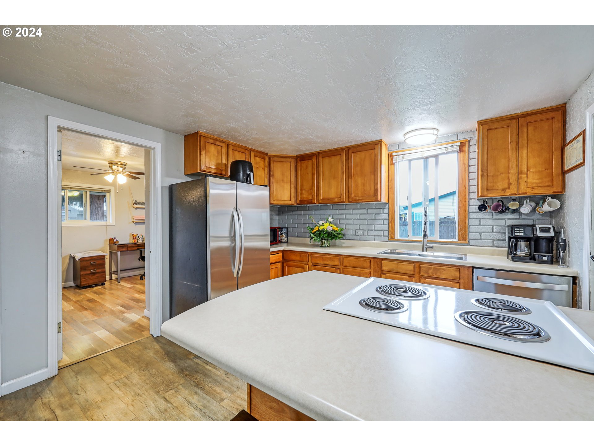 615 48th Street Springfield, OR 97478 - Photo 6 of 16 a kitchen with stainless steel appliances granite countertop a sink refrigerator and window