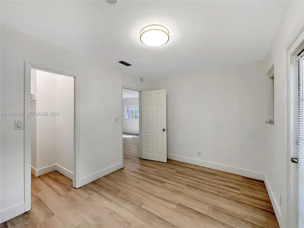 a view of a room with wooden floor