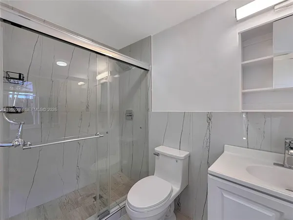 a bathroom with a toilet a sink and shower