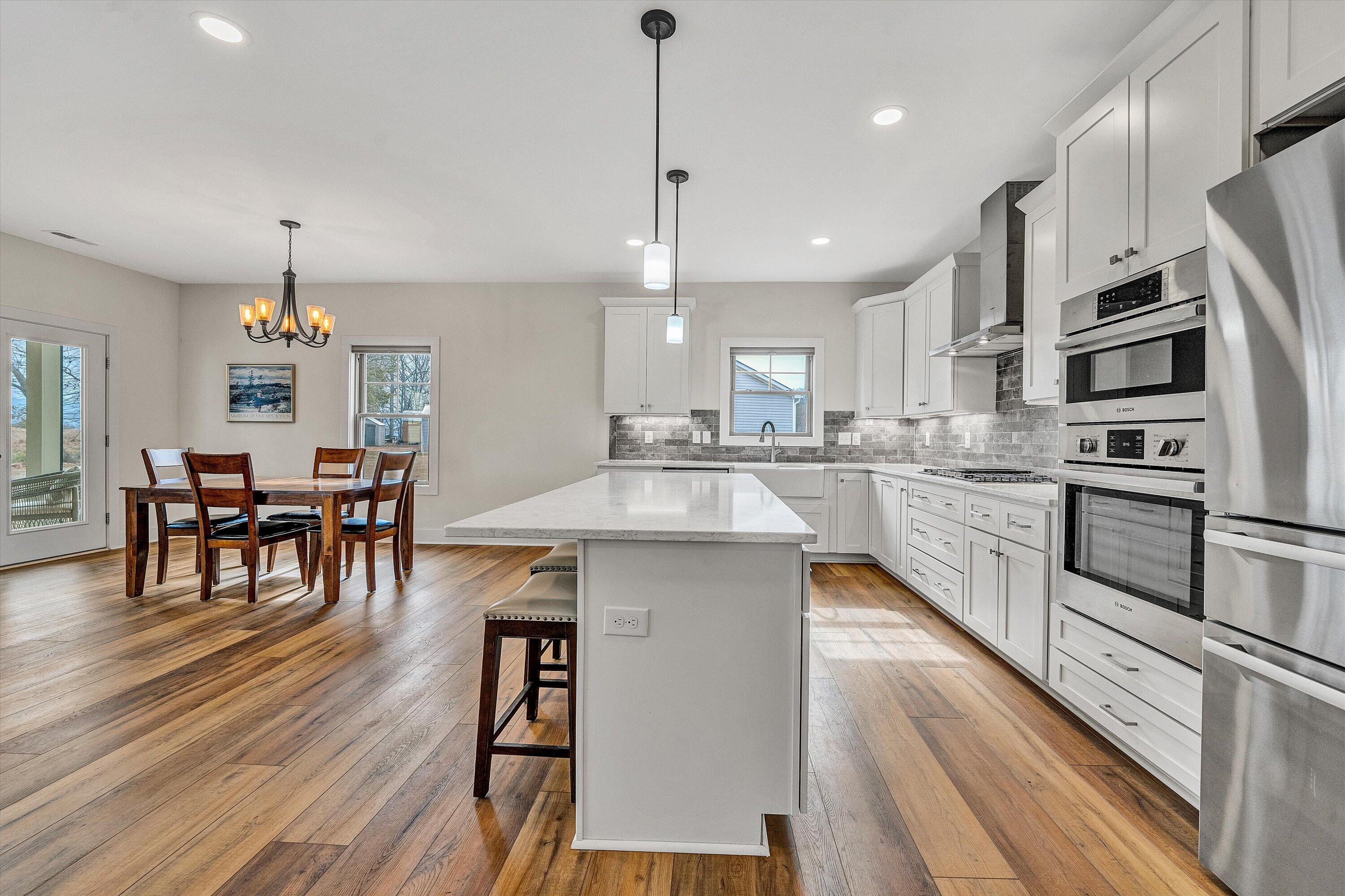 17 Alpine Drive Union Hall, VA 24176 - Photo 16 of 39 a kitchen with stainless steel appliances kitchen island granite countertop a stove a sink a refrigerator and chairs