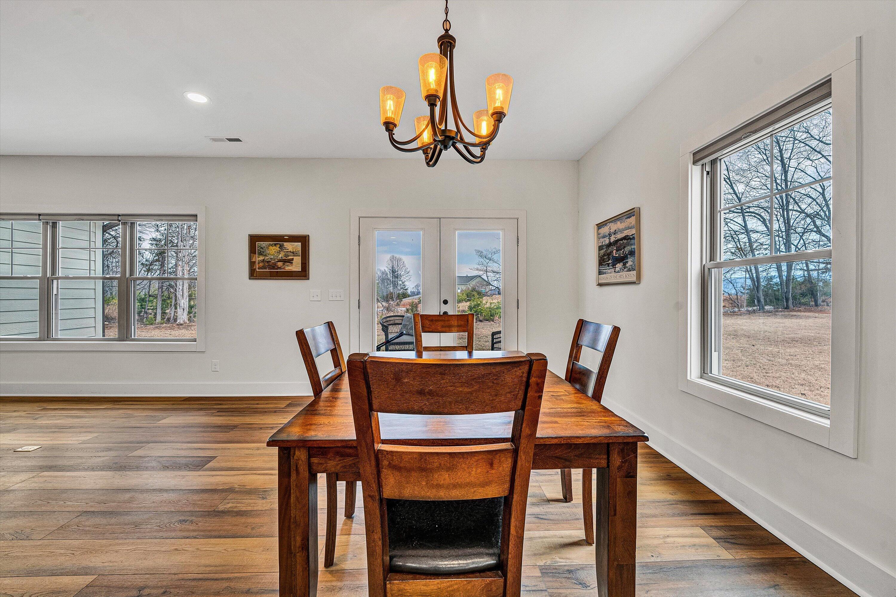 17 Alpine Drive Union Hall, VA 24176 - Photo 18 of 35 a dining room with wooden floor and a chandelier