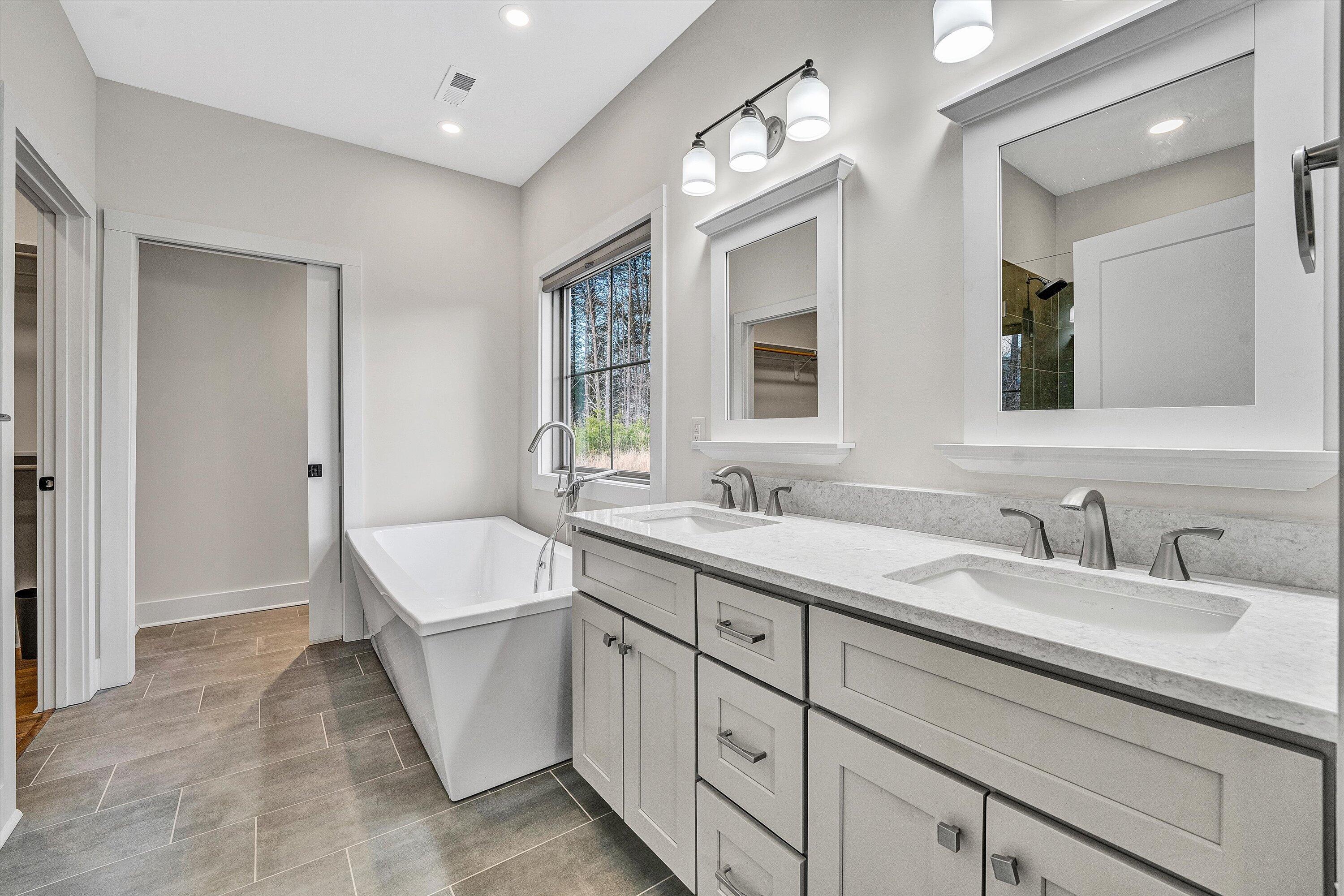 17 Alpine Drive Union Hall, VA 24176 - Photo 24 of 35 a spacious bathroom with a double vanity sink a large mirror and a bathtub