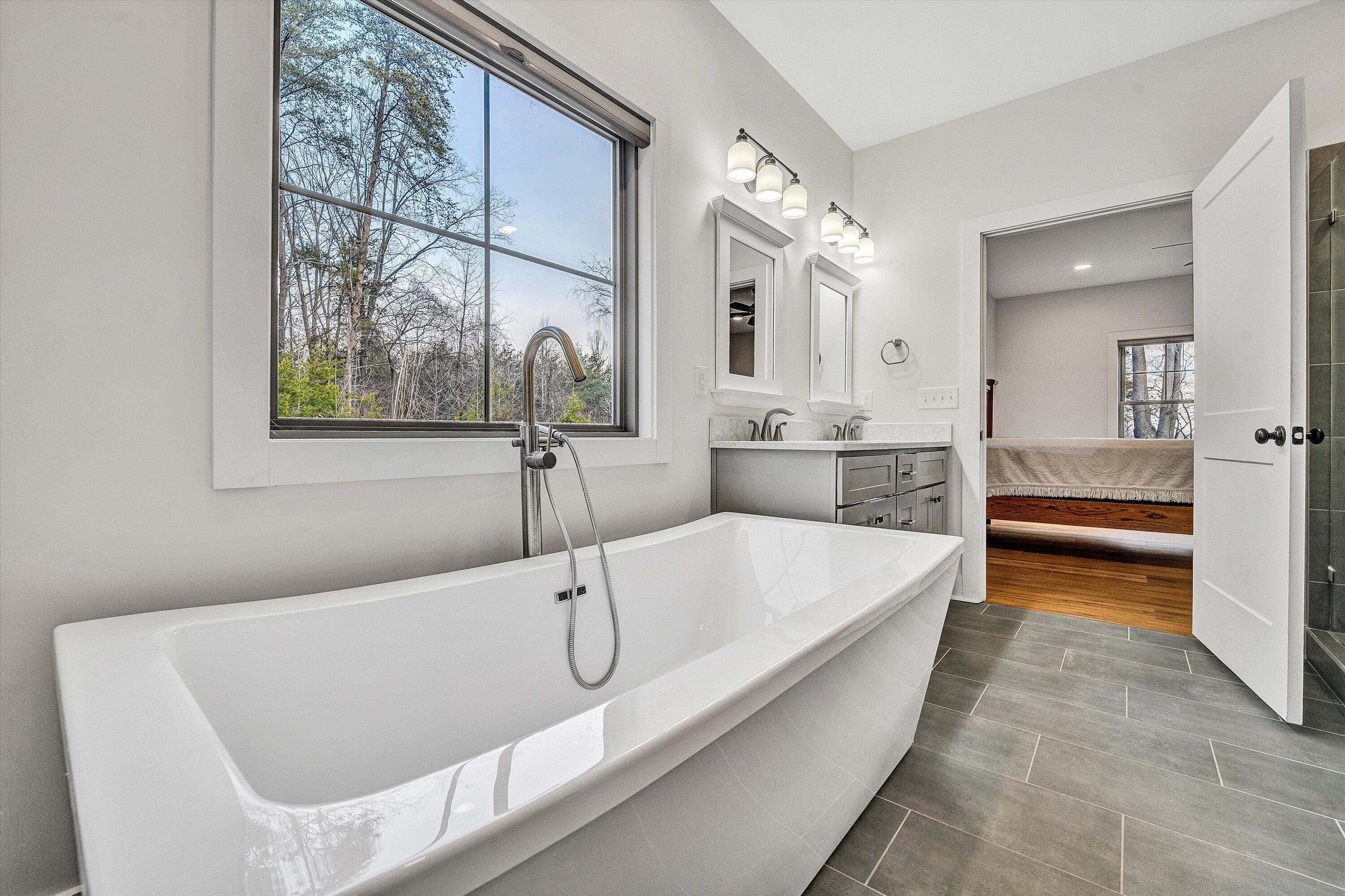 17 Alpine Drive Union Hall, VA 24176 - Photo 26 of 35 a bathroom with a tub a double vanity sink and mirror