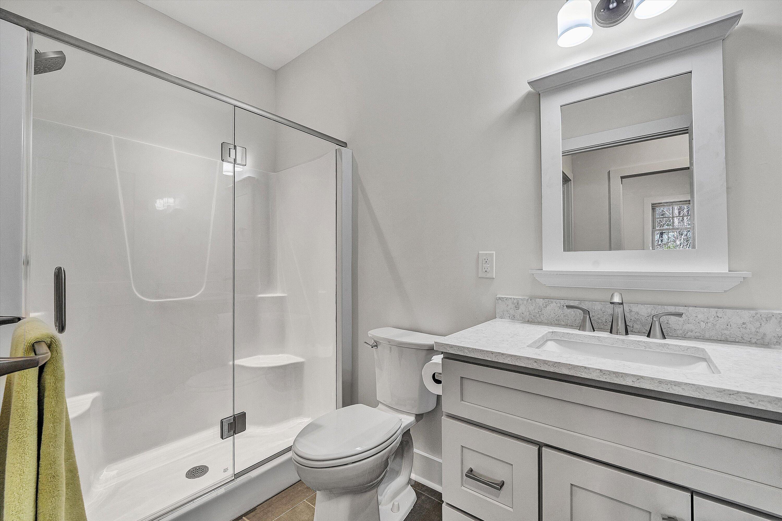 17 Alpine Drive Union Hall, VA 24176 - Photo 27 of 35 a bathroom with a sink a mirror a toilet and shower