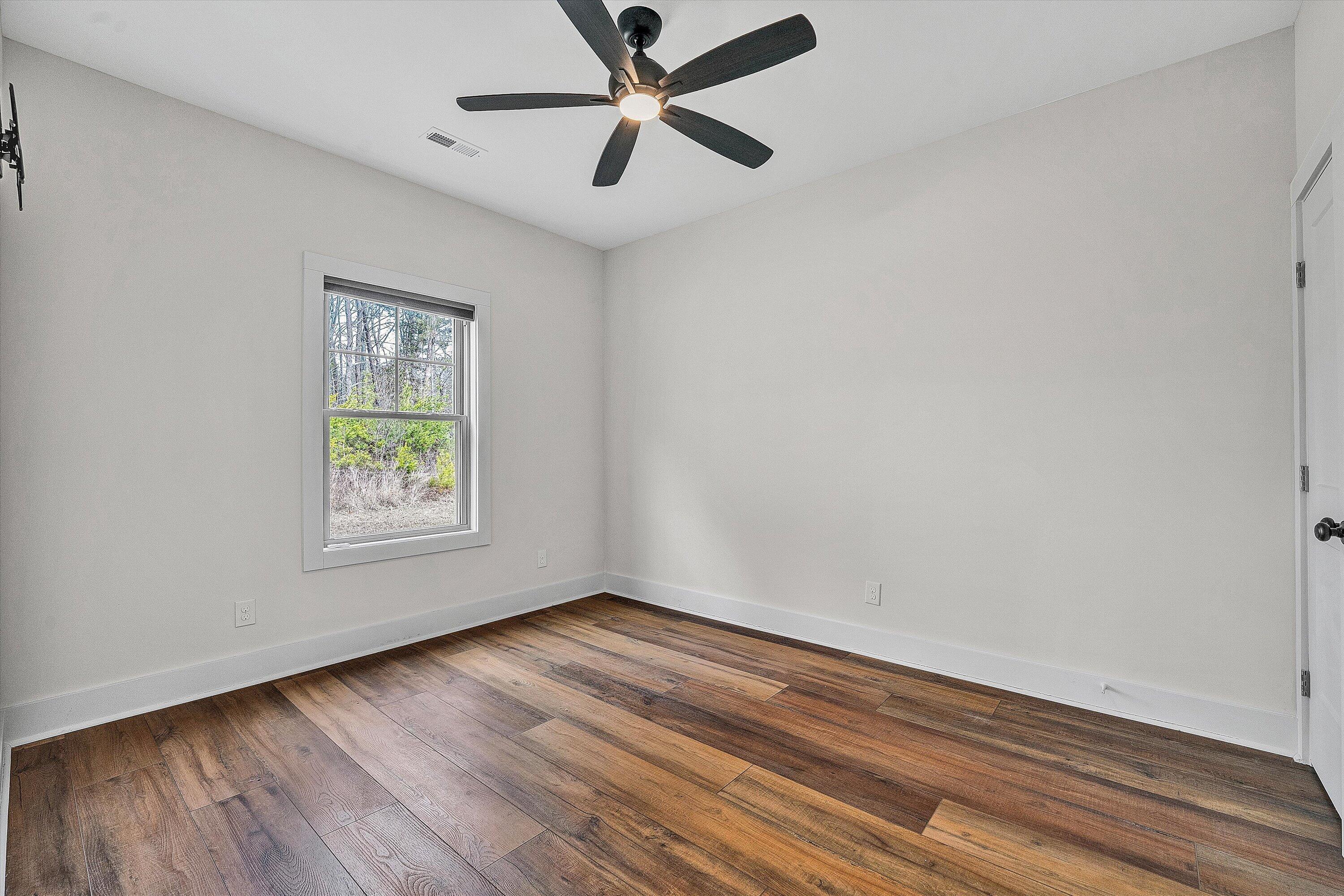 17 Alpine Drive Union Hall, VA 24176 - Photo 29 of 35 an empty room with wooden floor fan and windows