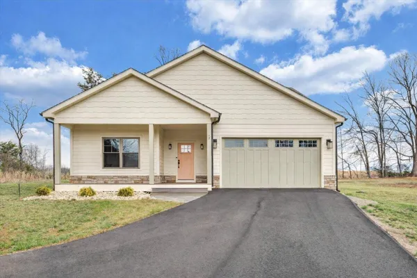 a kitchen with stainless steel appliances granite countertop a refrigerator a oven a sink and white cabinets with wooden floor