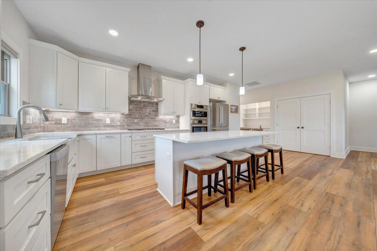 17 Alpine Drive Union Hall, VA 24176 - Photo 9 of 39 a large kitchen with kitchen island a dining table chairs and white cabinets